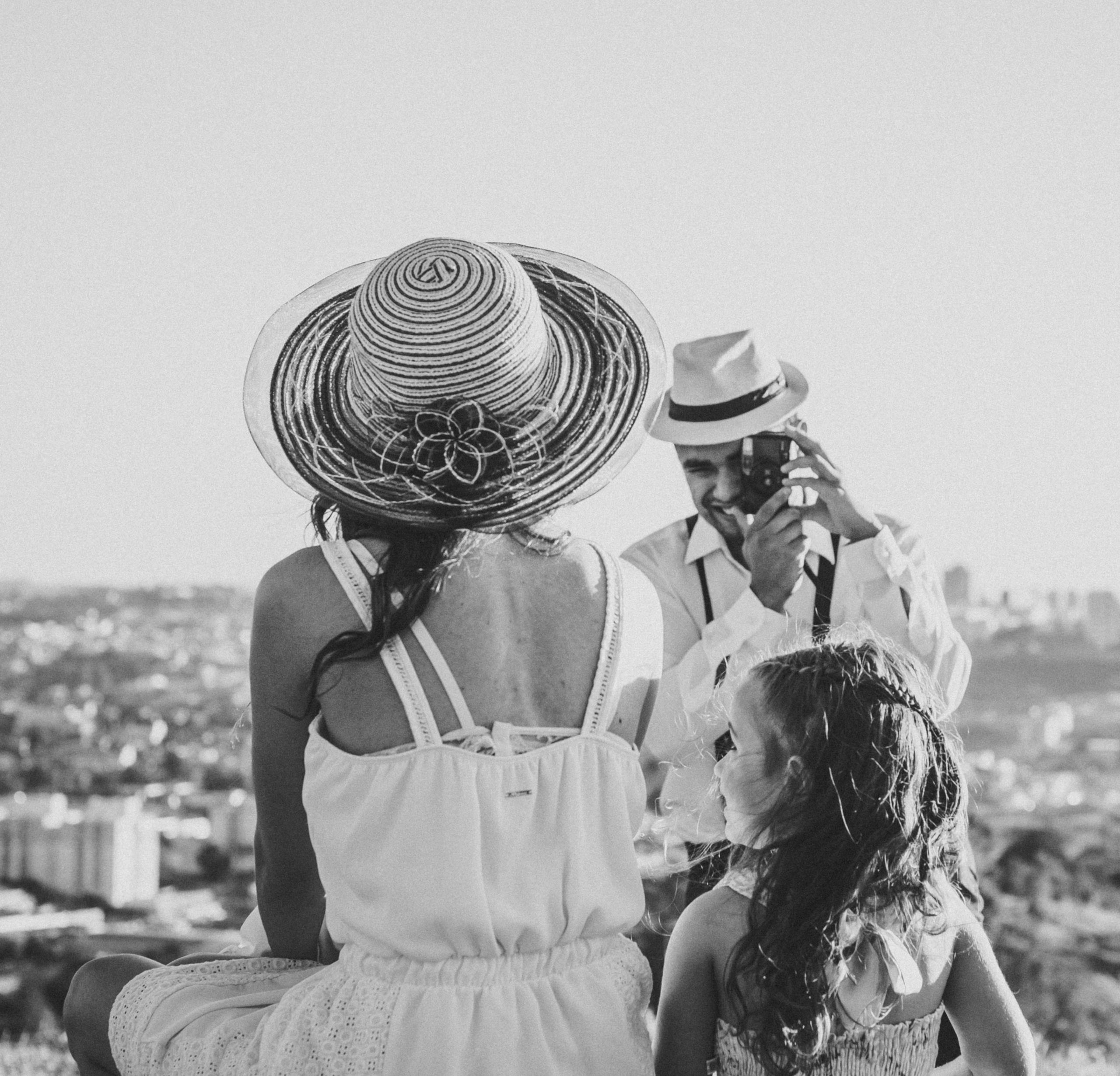 A black and white family portrait of a couple and child overlooking Sorocaba, Brazil on a sunny day.